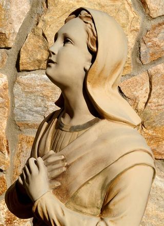 Statue of Saint Bernadette Kneeling before the Blessed Mother