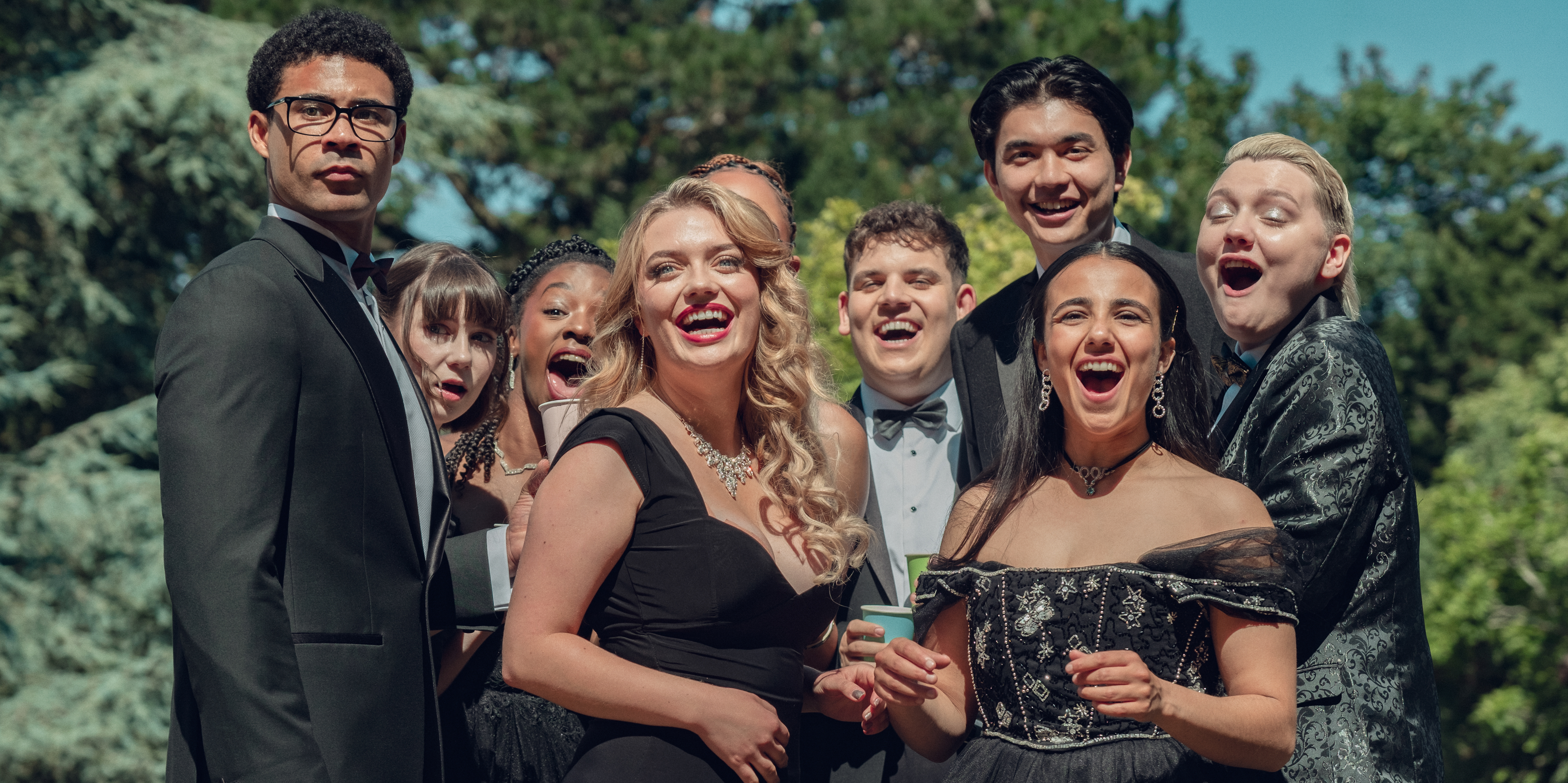 Darragh Hand, Jenny Walser, Corrina Brown, Rhea Norwood, Tobie Donovan, Will Gao, Leila Khan, and Kizzy Edgell all dressed in black looking off into the distance smiling in heartstopper forever