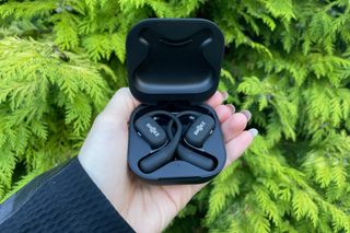 Shokz OpenFit earphones inside the charging case