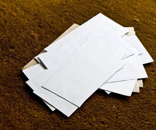 A pile of mail on a doormat