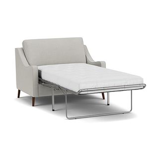 A loveseat chair bed with pale grey upholstery