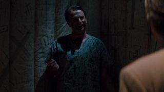 John Trent covered in crosses in asylum for In the Mouth of Madness