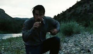 Josh Brolin takes out the dog chasing him in No Country For Old Men