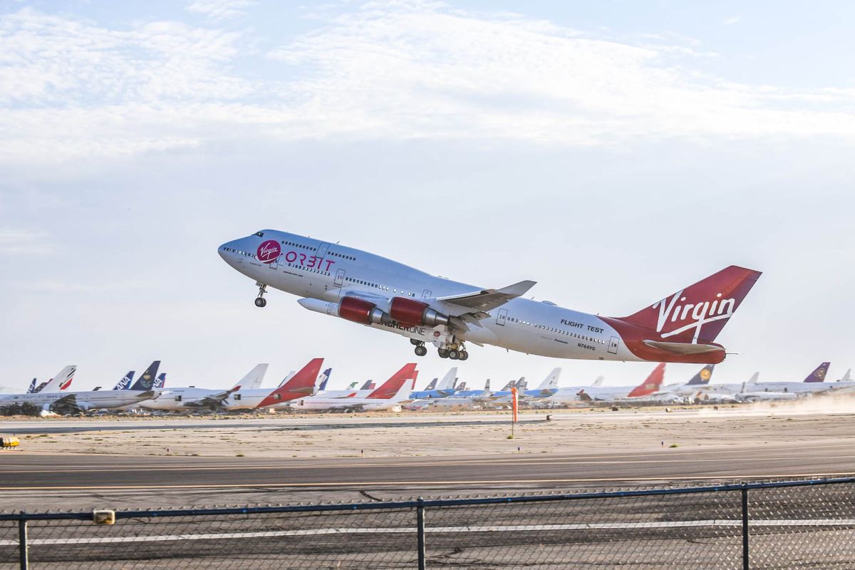 Virgin Orbit&#039;s carrier aircraft Cosmic Girl takes off from Mojave Air and Space Port in California with the LauncherOne rocket underwing on June 30, 2021.