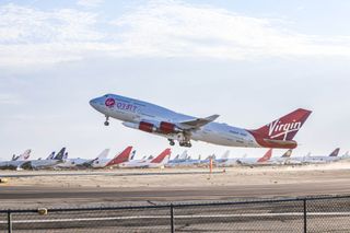 Virgin Orbit's carrier aircraft Cosmic Girl takes off from Mojave Air and Space Port in California with the LauncherOne rocket underwing on June 30, 2021.