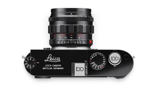 Leica camera with Leica 100-branded hot shoe cover and shutter release