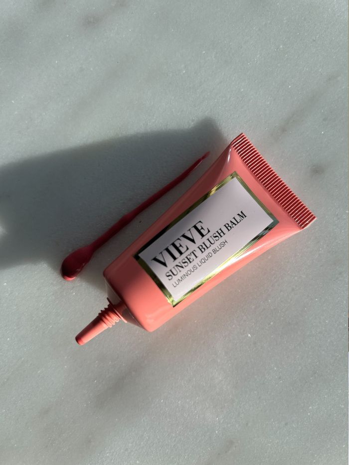 The Vieve Sunset Blush Balm on a marble background