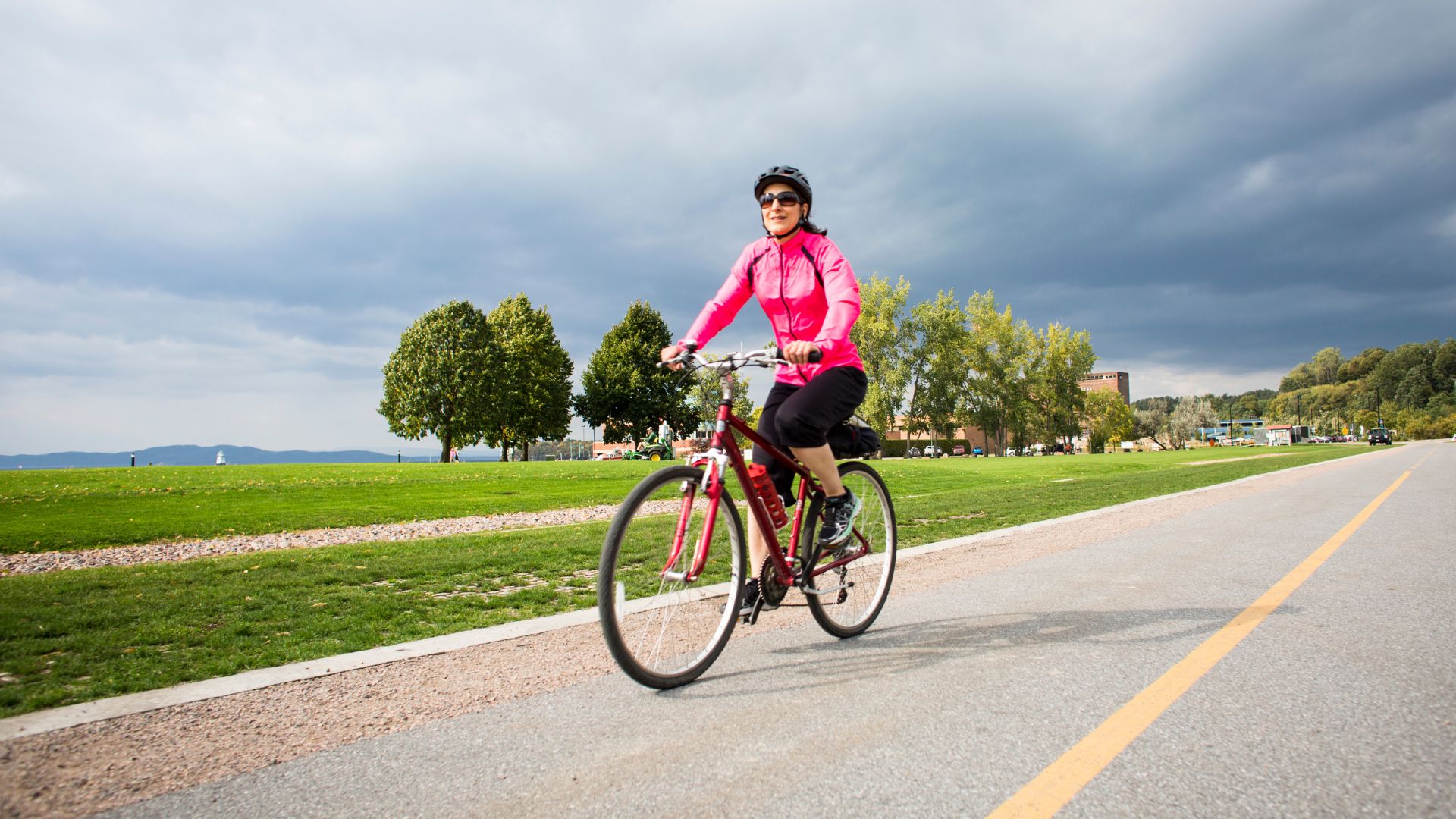 Woman cycling along a road