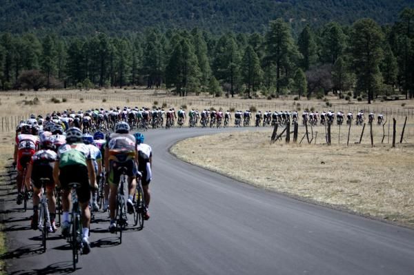 The men's peloton gets strung out on one of the few flat sections today.