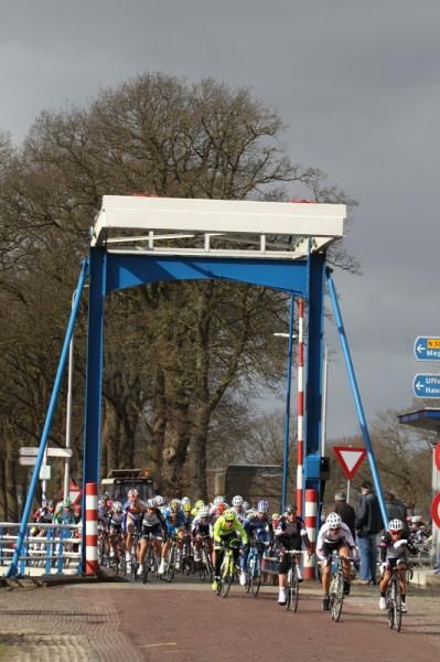 The peloton crosses a bridge on the way back to Dwingeloo