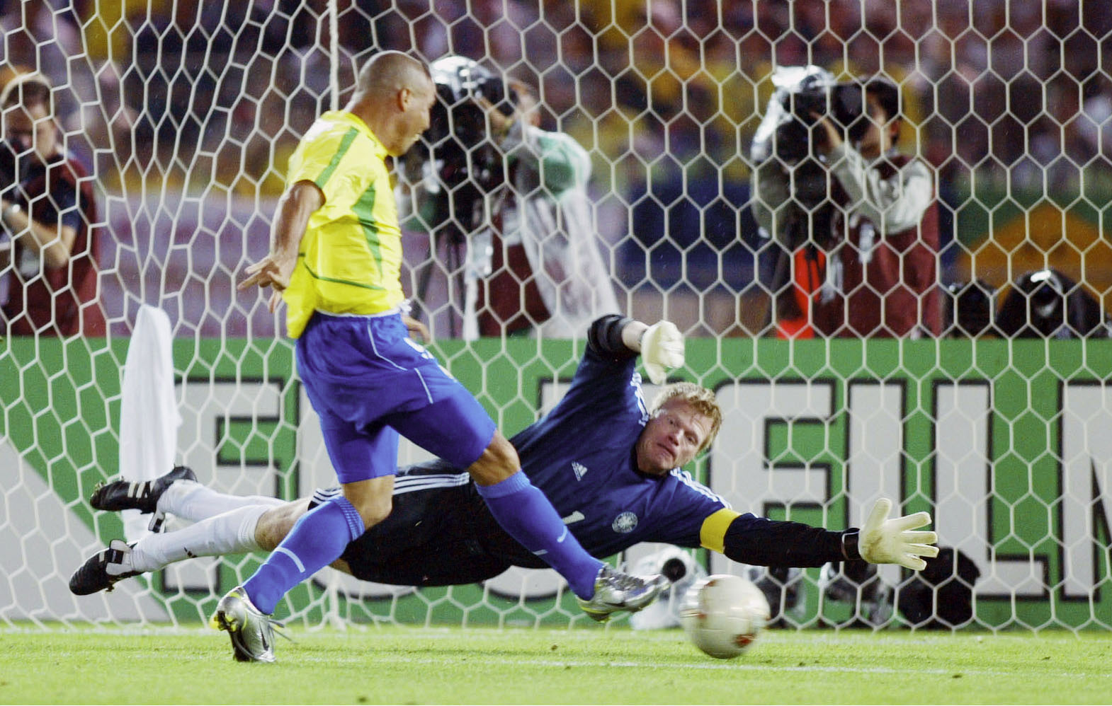 Brazil striker Ronaldo scores past Germany goalkeeper Oliver Kahn in the 2002 World Cup final.