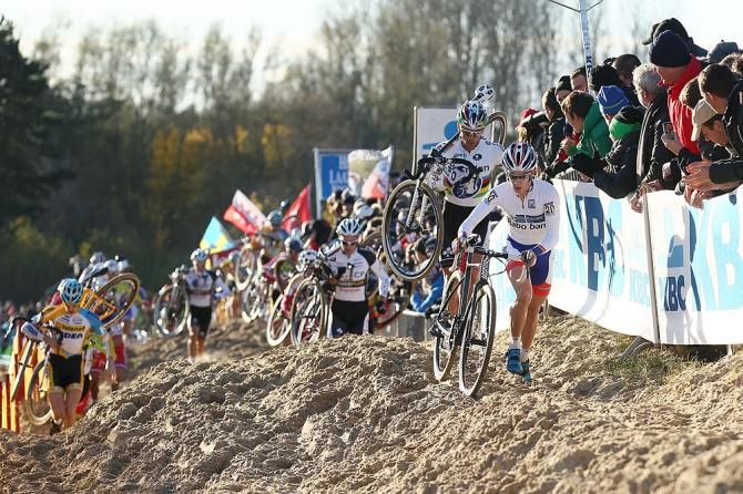 The peloton runs through the sand