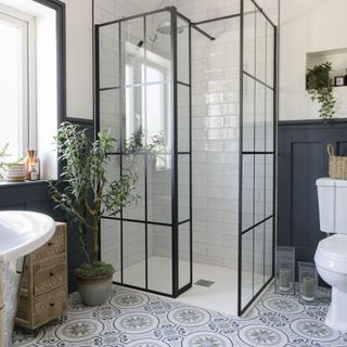 blue patterned floor in bathroom with walk in shower