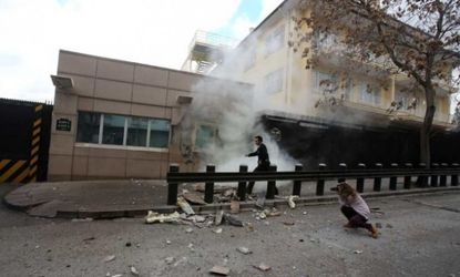 A security officer runs after an explosion at the entrance of the U.S. embassy in Ankara, Turkey, on Feb. 1.