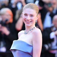 Hunter Schafer on the Cannes 2024 red carpet wearing an Armani Prive gown with pockets