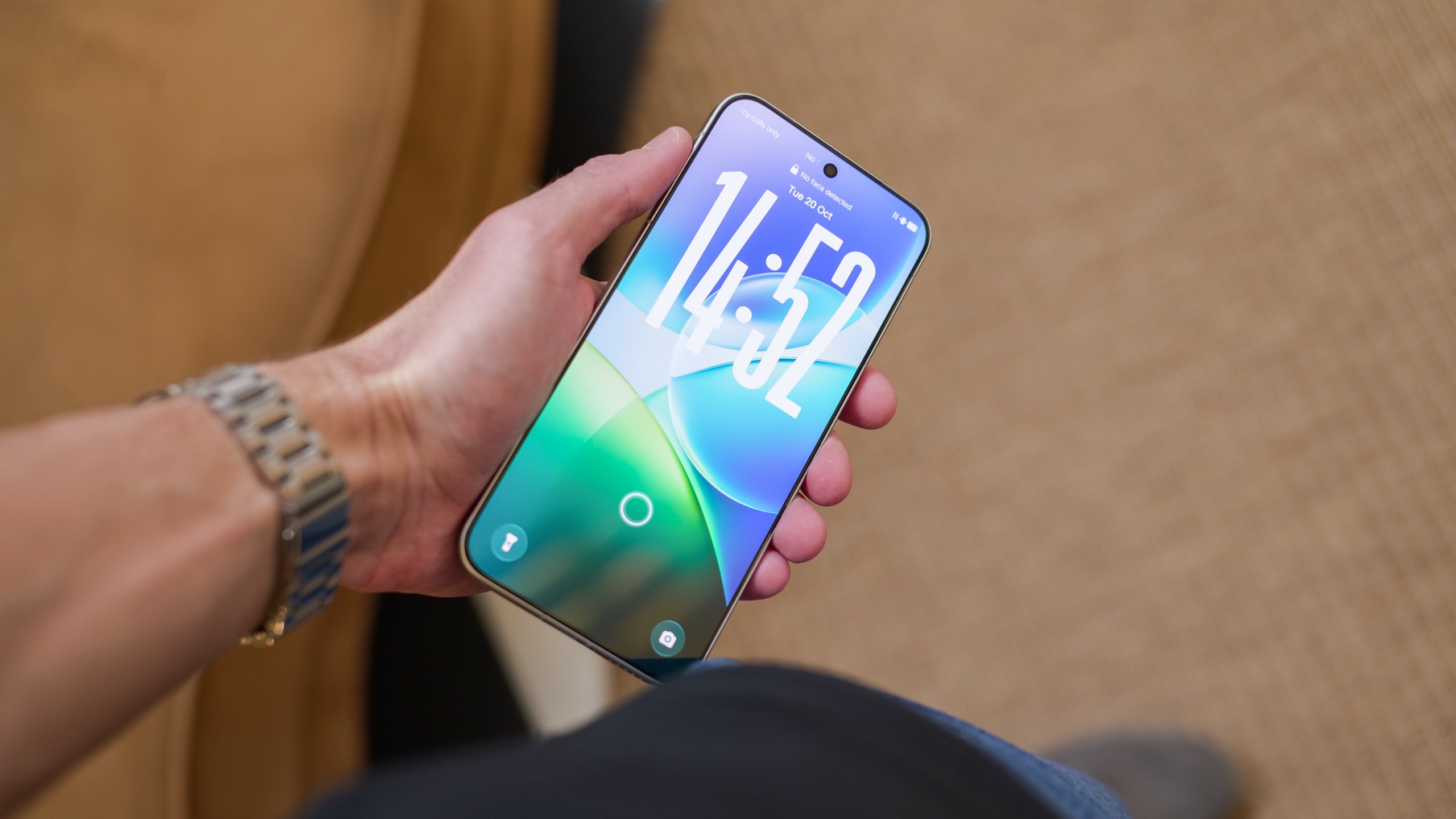 Vivo X500 Pro Max held in one hand with the front display illuminated, showing the lock screen and edge-to-edge display.