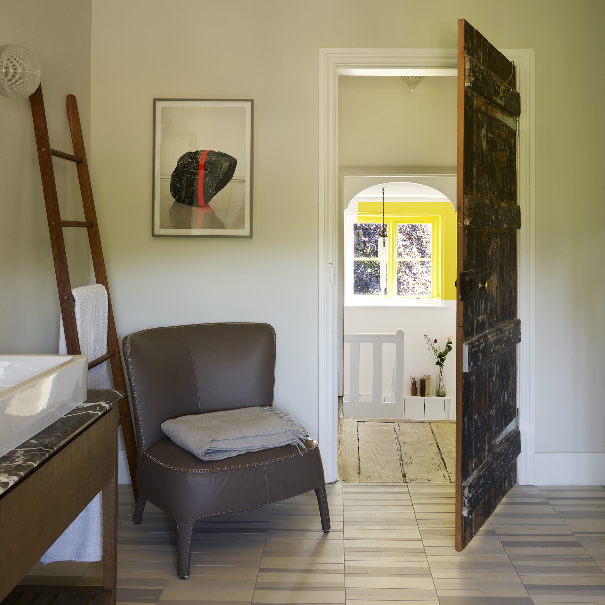Bathroom with armchair in corner