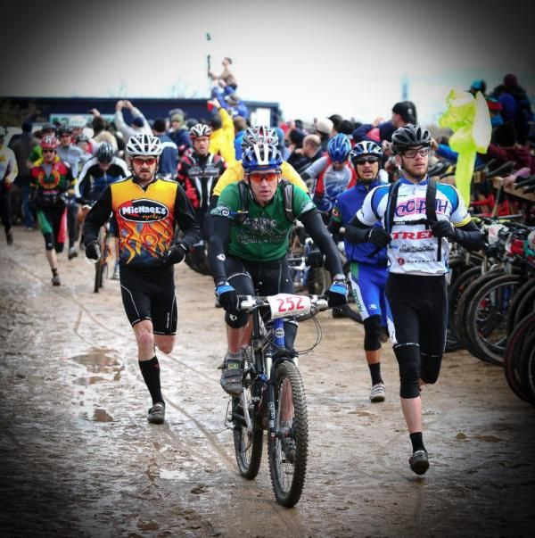 Racers run a quarter mile to claim their bikes in a mass Le Mans start.
