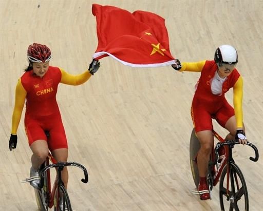 China's Shuang Guo, left, and Junhong Lin celebrate their gold and silver medals in the women's sprint.