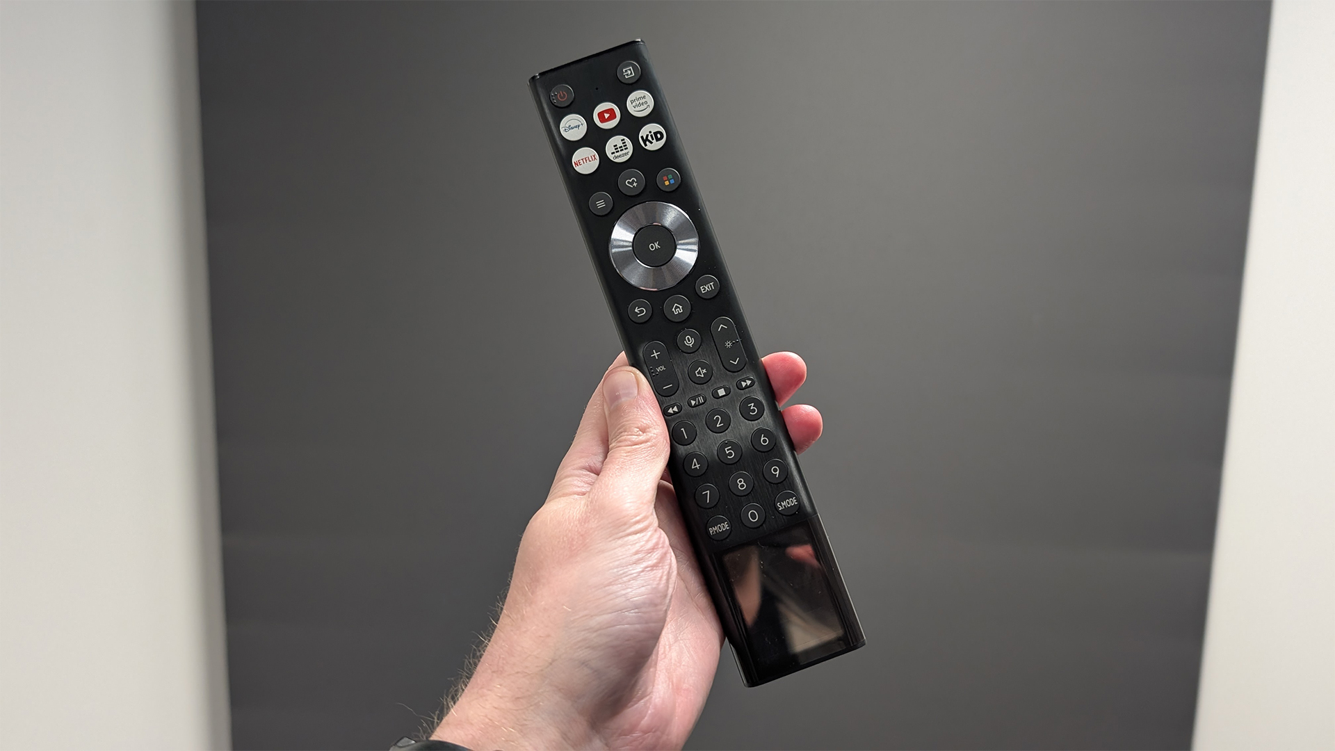 Hisense PX3 ultra short throw projector remote control held in hand