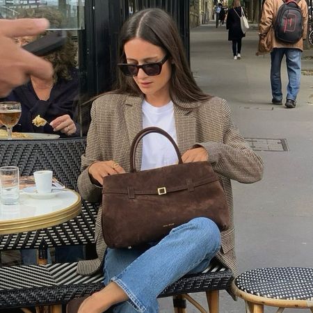 Influencer wears suede ballet flats.