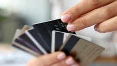 Hand choosing a credit card from several offered.