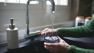 woman filling up a glass of water