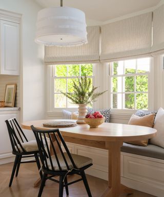 eat in kitchen with oval table and banquette window seat