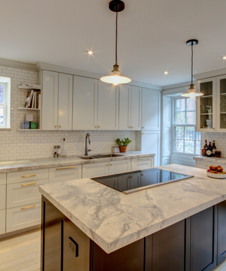 A white kitchen with a pop-up range hood