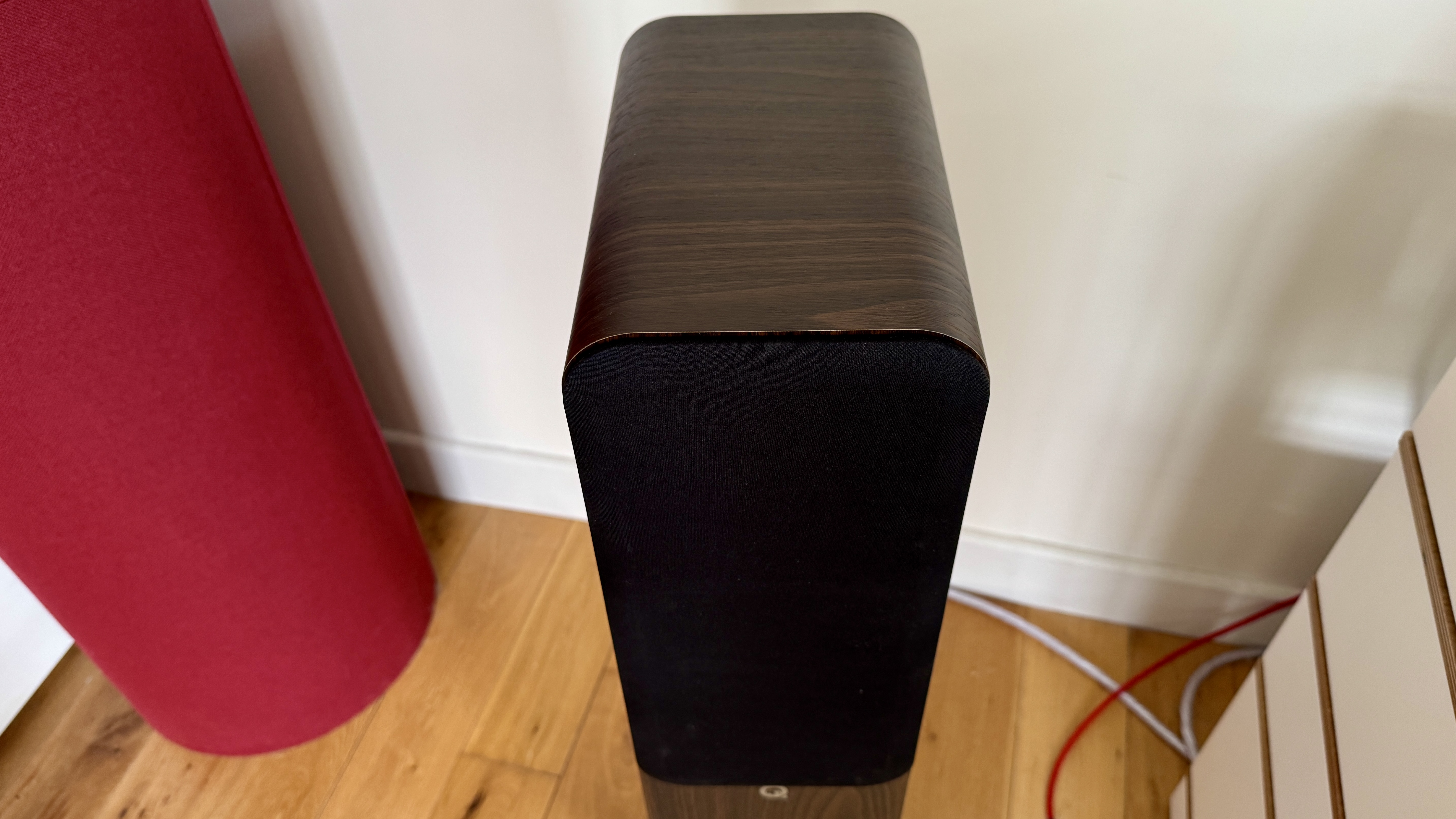 Q Acoustics 3040c speakers in a white listening room, with a hi-fi stack and turntable between them