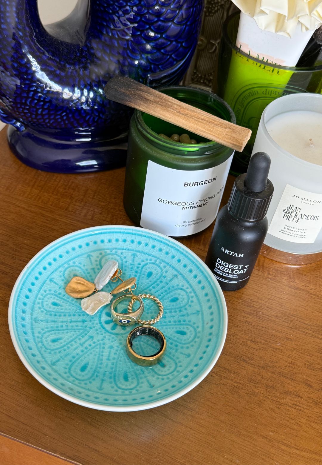 Health writer Anna Bartter's Oura ring review: A shot of the Oura fitness tracker ring on her dresser
