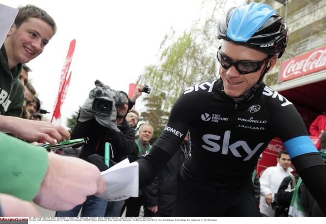 Chris Froome signs a few autographs at the start