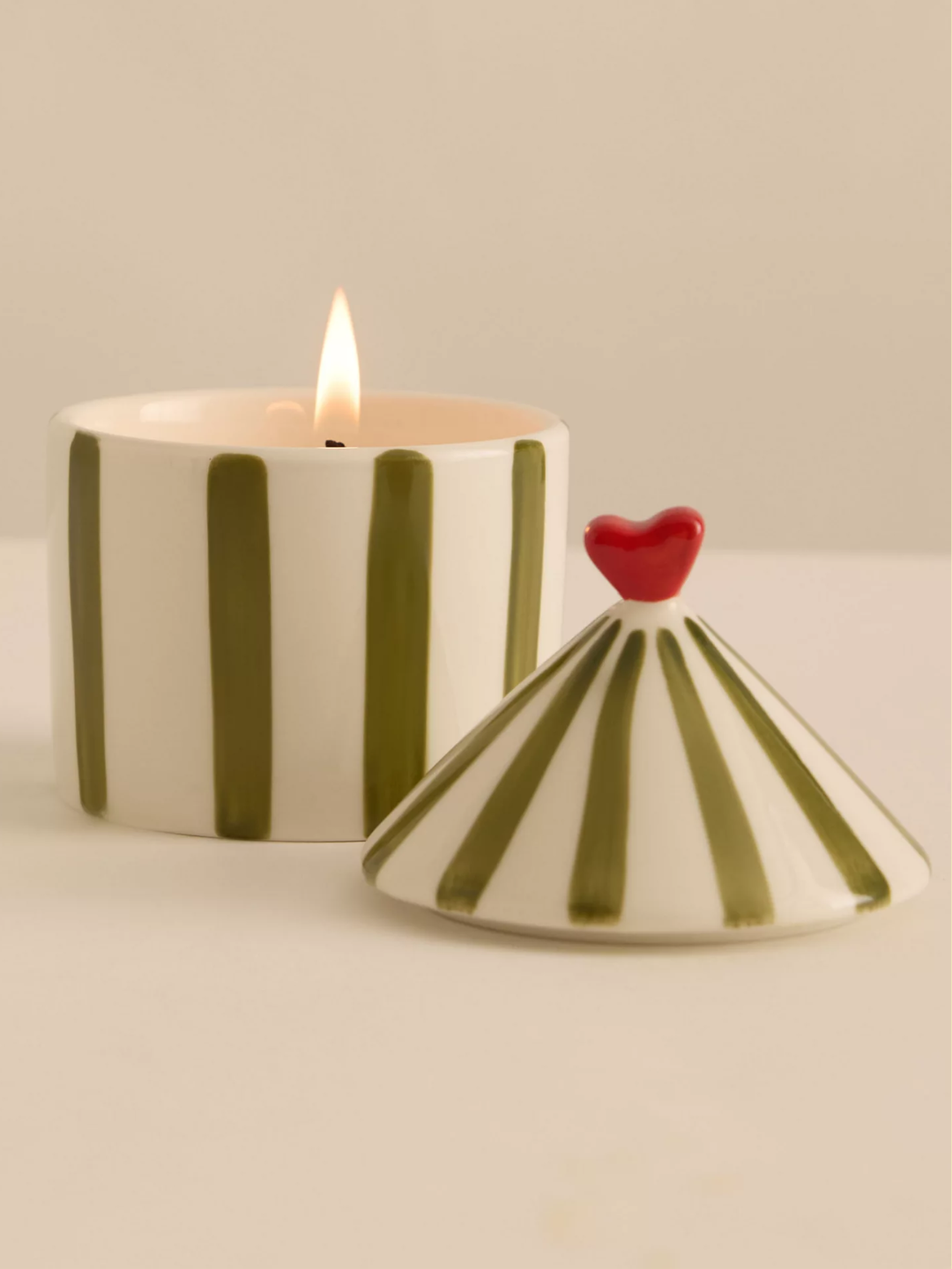 A striped circus-themed tomato candle from Zesty Lemons Candle