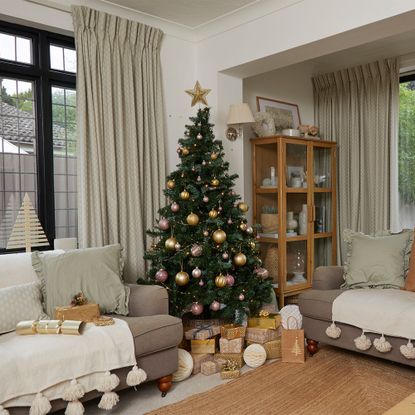 Neutral living room with sofa and Christmas tree