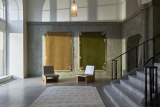 Rugs on wall and floor at Nordic Knots Stockholm Showroom in a former theatre