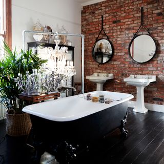 bathroom with brick walls and bathtub