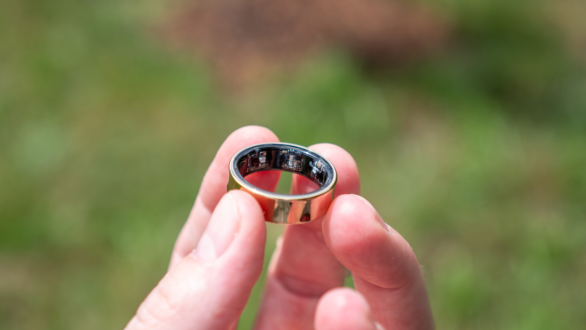 Holding the gold Samsung Galaxy Ring