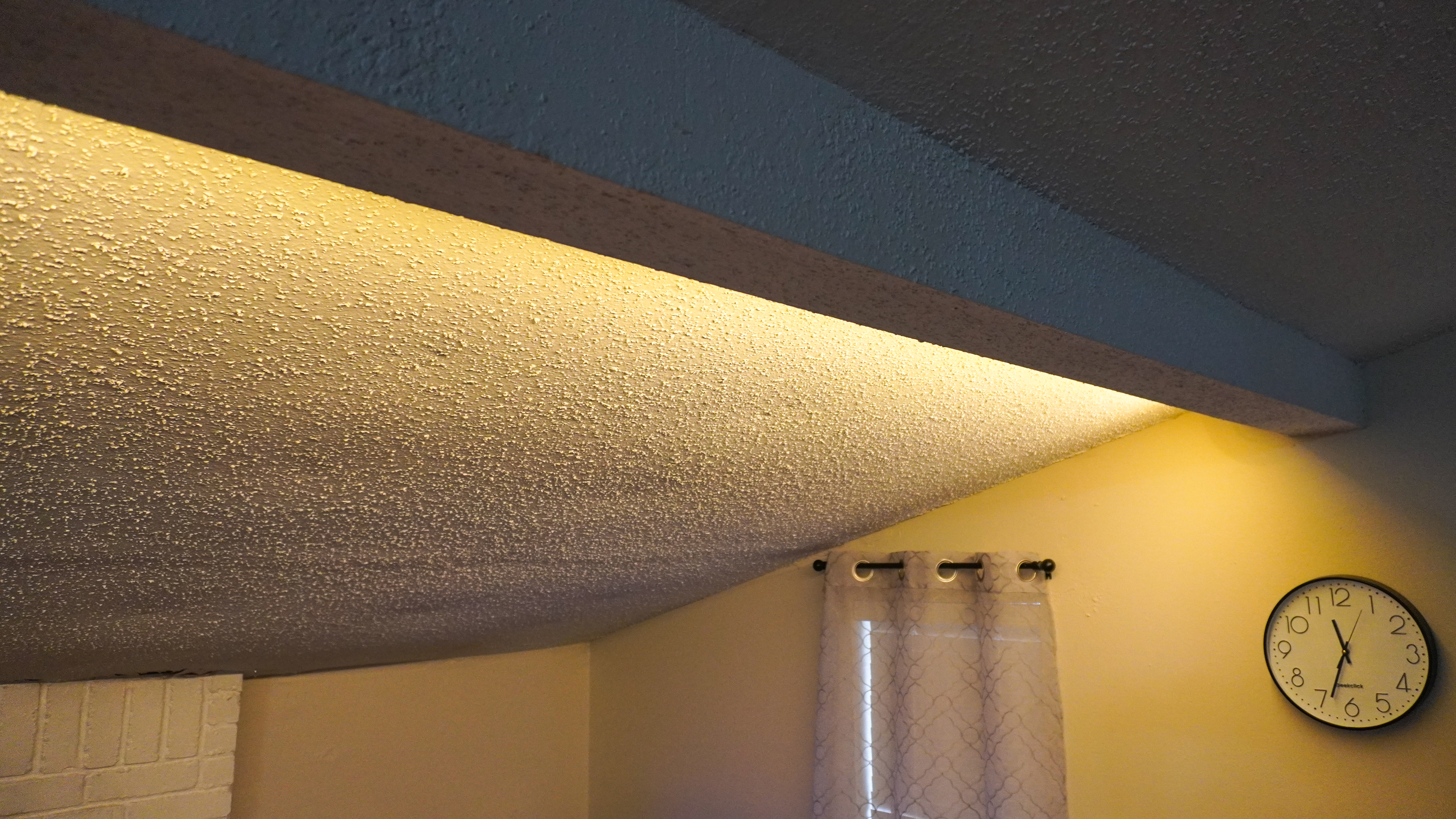A wide shot showing the Govee Strip Light with Skyline Kit mounted behind a beam and completely out of sight