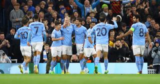 Erling Haaland celebrates with Julian Alvarez and Ruben Dias of Manchester City after scoring their team's second goal during the UEFA Champions League group G match between Manchester City and FC Copenhagen at Etihad Stadium on October 05, 2022 in Manchester, England.