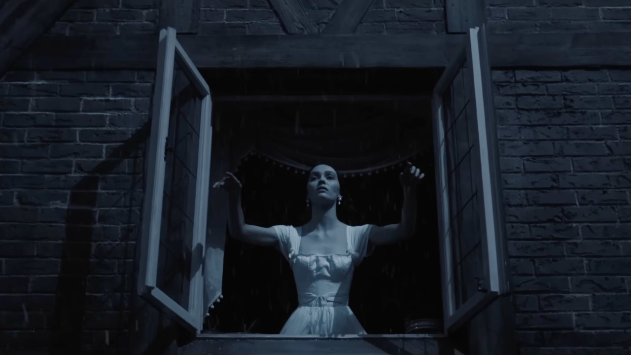 Lily-Rose Depp opening a window under the moonlight in 2024's Nosferatu.