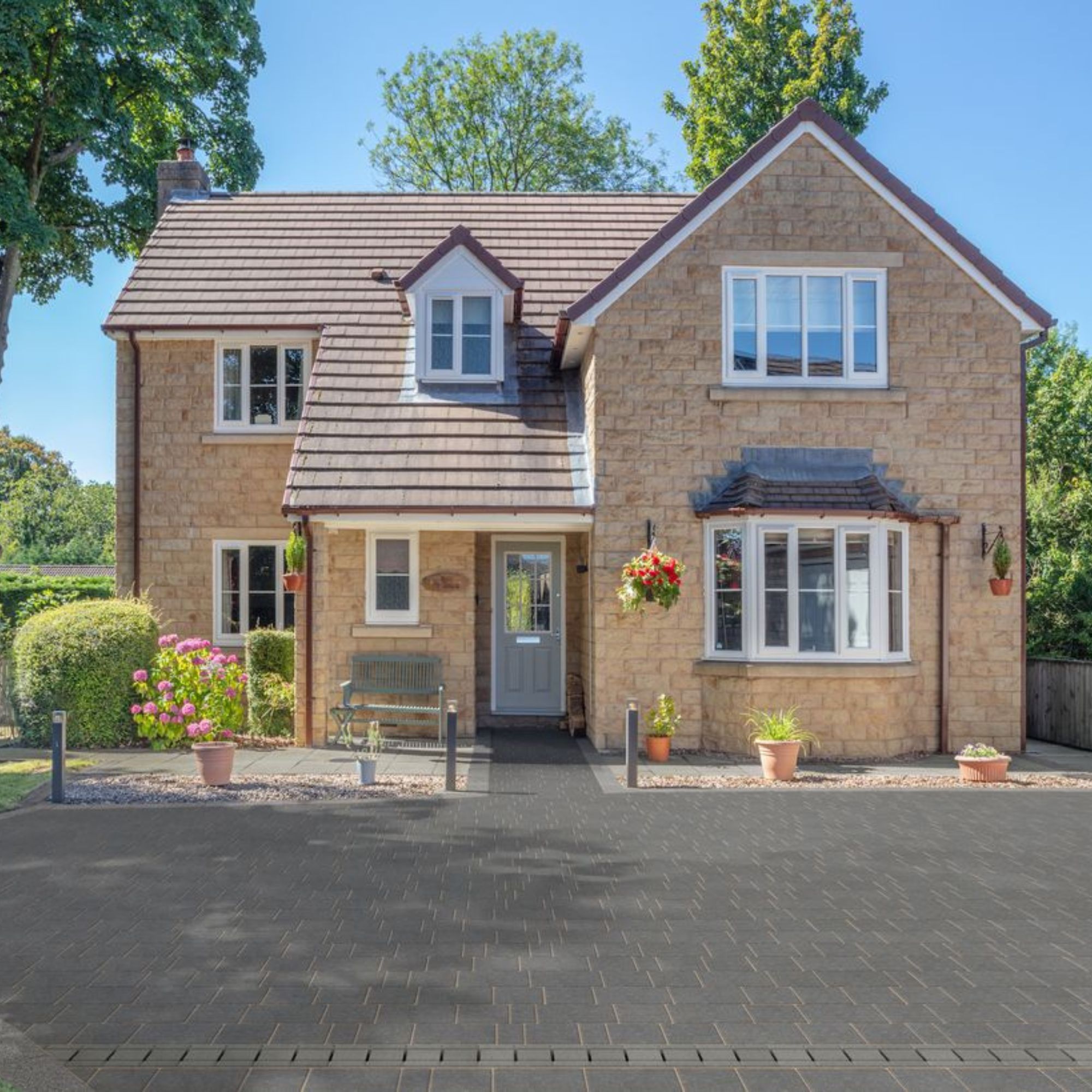 Modern detached house with block paved driveway in front