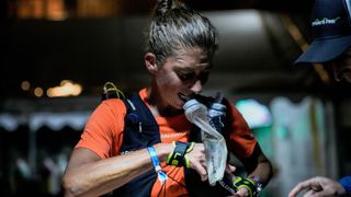 Courtney Dauwalter drinking water while running in the UTMB Nice