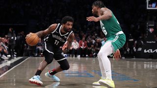 Kyrie Irving #11 of the Brooklyn Nets drives against Marcus Smart #36 of the Boston Celtics