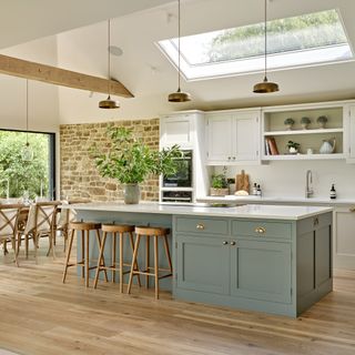 Soft duck egg blue kitchen in a country room with warm wood flooring