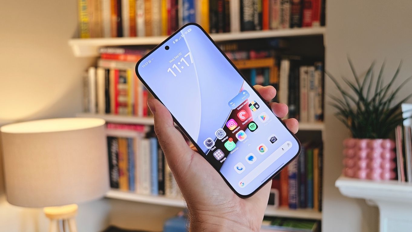 The Poco F9 Ultra being held in the hand and resting on a table
