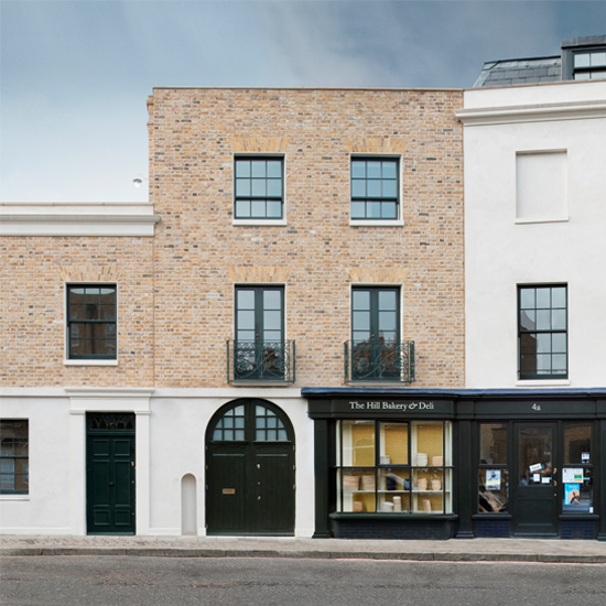 bricked wall building with black door and windows