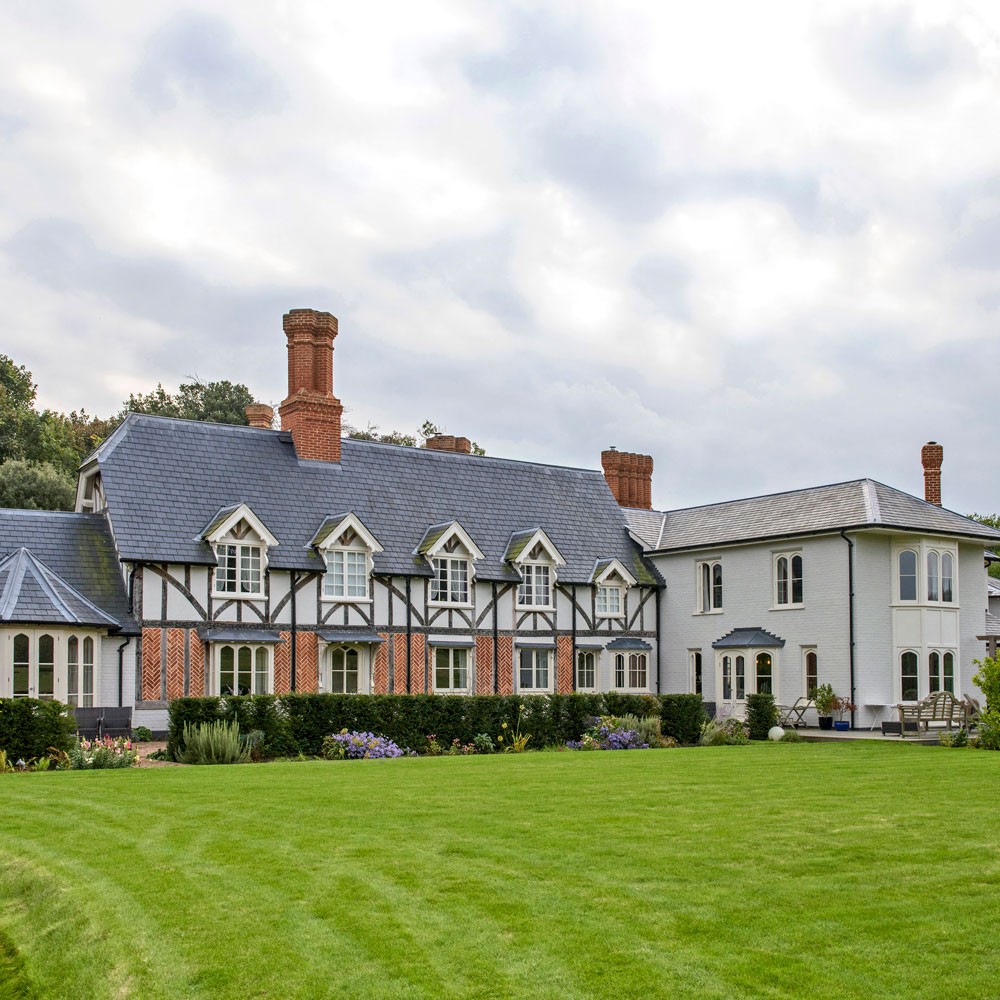 house exterior with lawn and flower plants