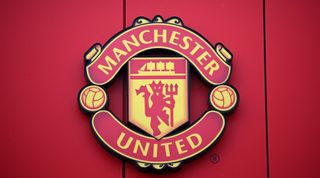 Close-up shot of a Manchester United club crest on the exterior of Old Trafford, home stadium of Manchester United FC in Manchester, United Kingdom