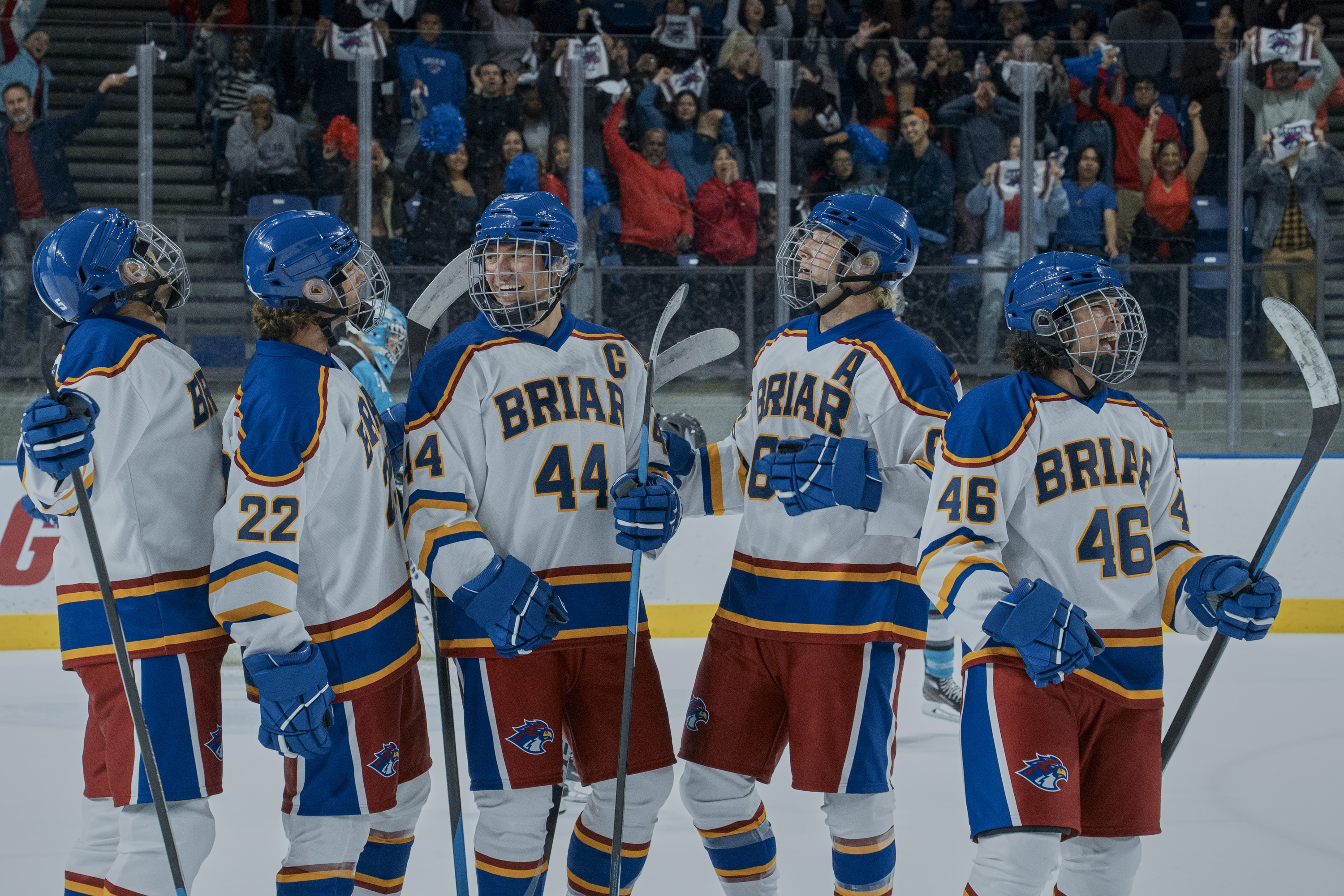 Logan (Antonio Cipriano), Garrett (Belmont Cameli), Dean (Stephen Thomas Kalyn), and Tucker (Jalen Thomas Brooks) wearing white blue and red hockey uniforms while on the ice in off campus season 1