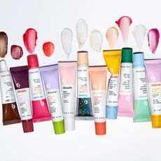 tubes of Glossier balm dot come on light grey background with swatches 